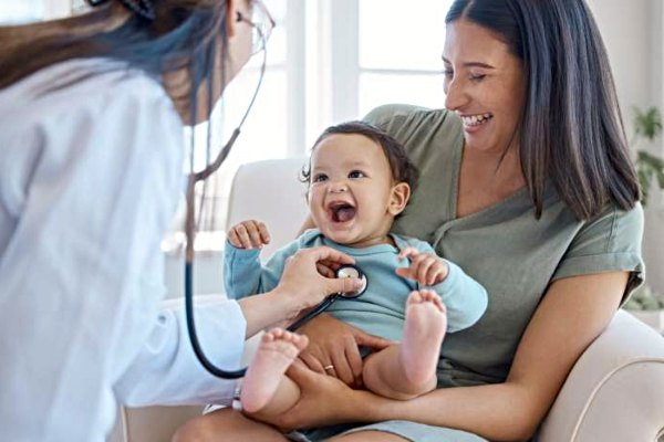 Infant smiling during doctor checkup