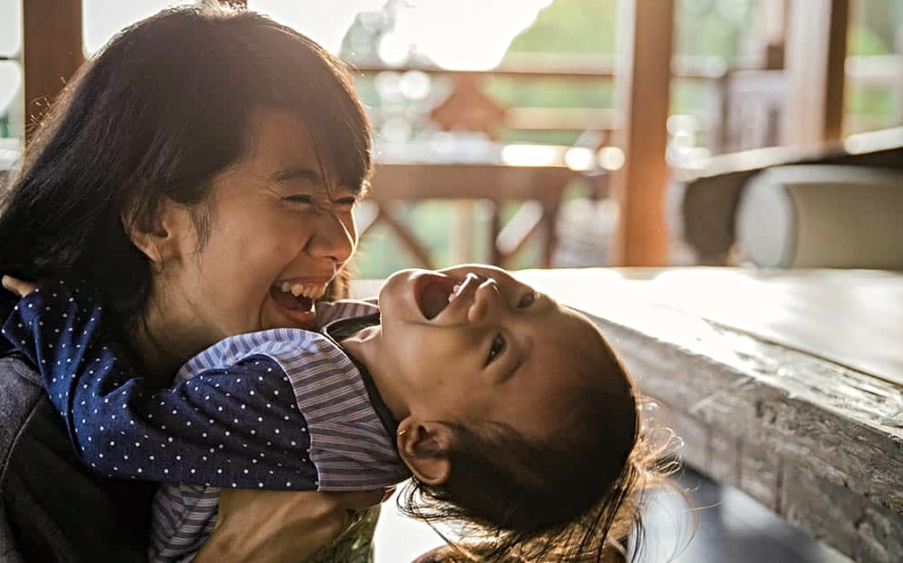 mother and baby laughing