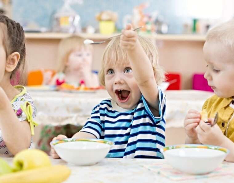 Babies are smiling and eating together