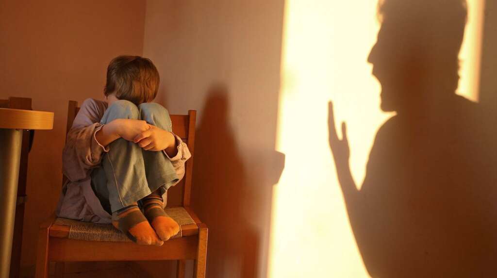 a man is shouting on a child and the child is afraid 