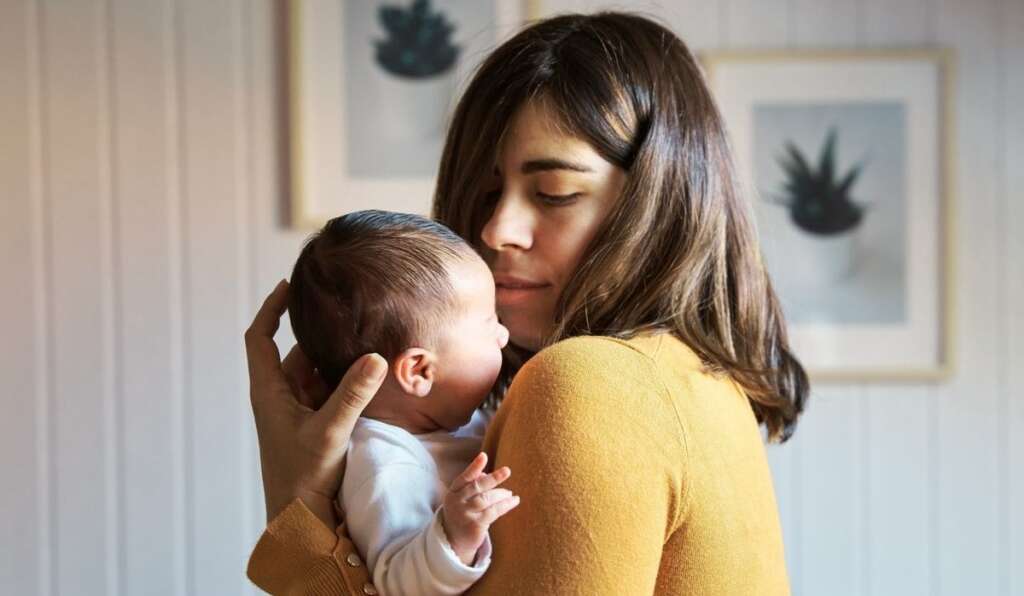 mother is holding and seeing a baby 