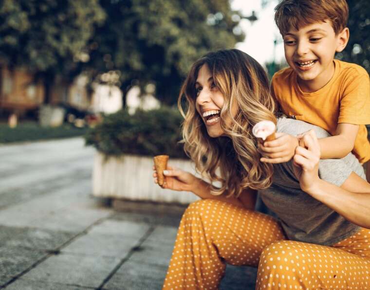Mother and son are laughing and enjoying icecream