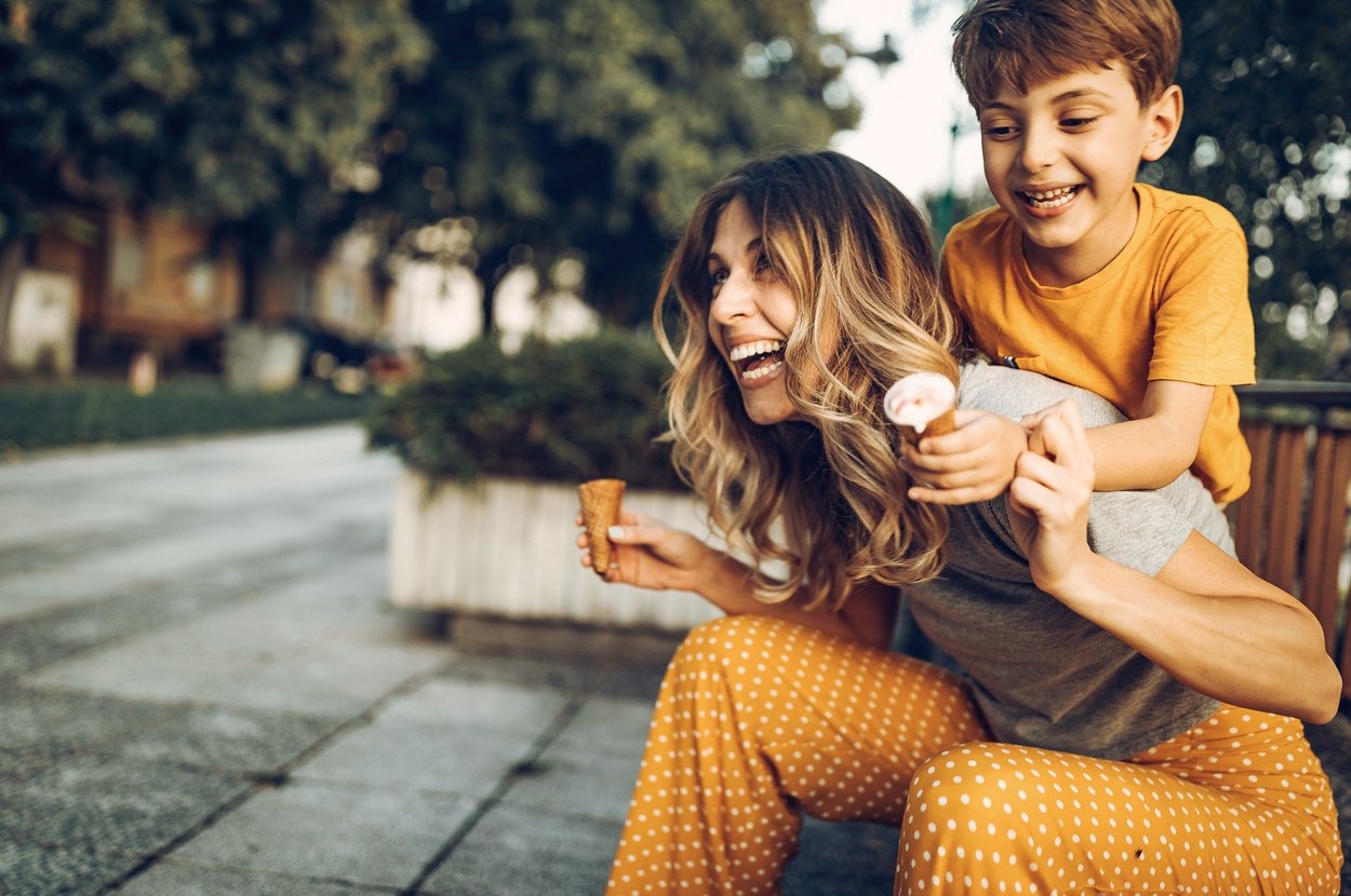 Mother and son are laughing and enjoying icecream