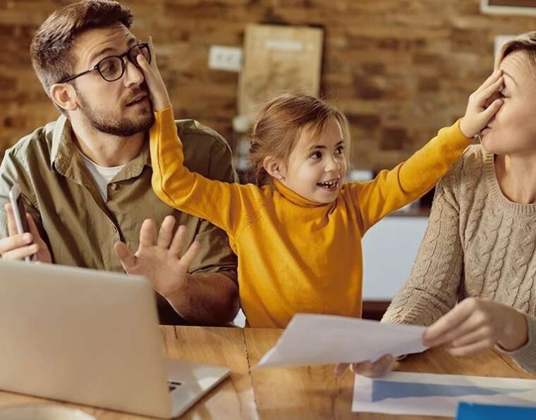 child is putting hand on parent's face (parenting styles)