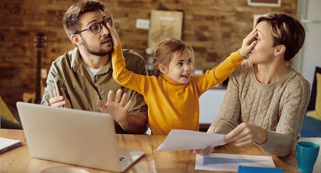 child is putting hand on parent's face (parenting styles)