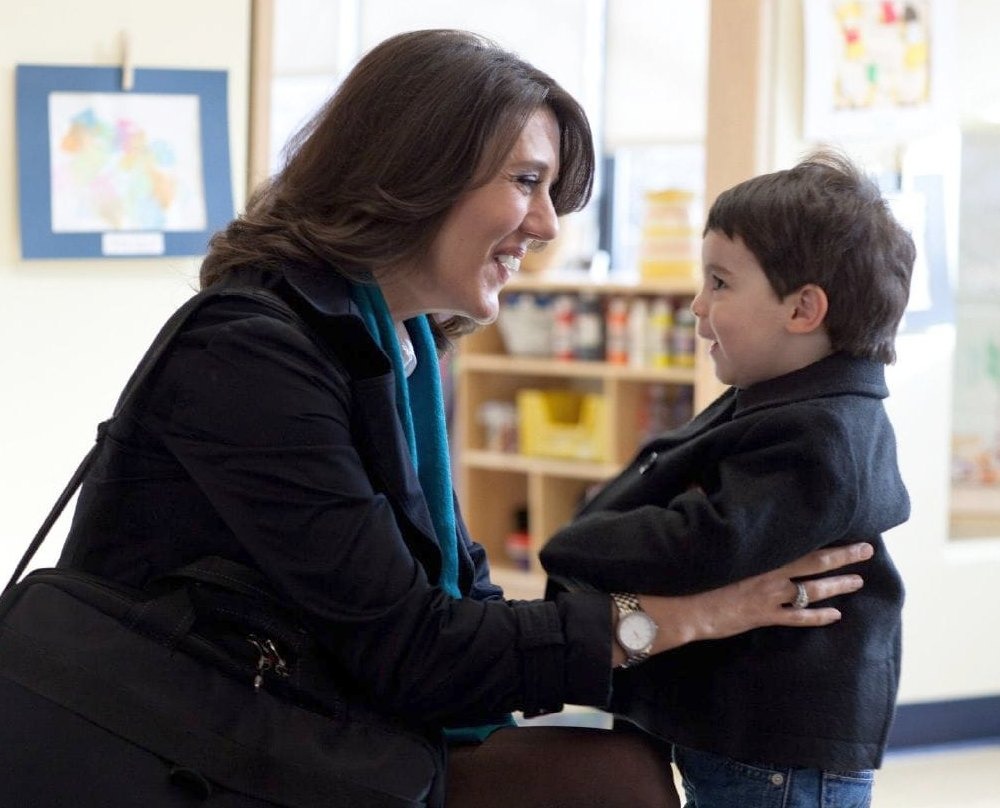 mother is trying to ask something of child (son) and both are smiling
