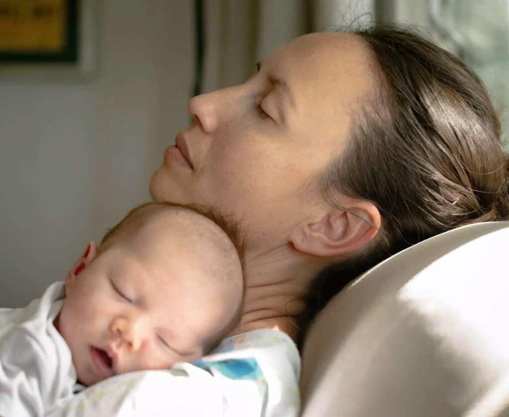 Postpartum Self Care and mother is holding newborn baby