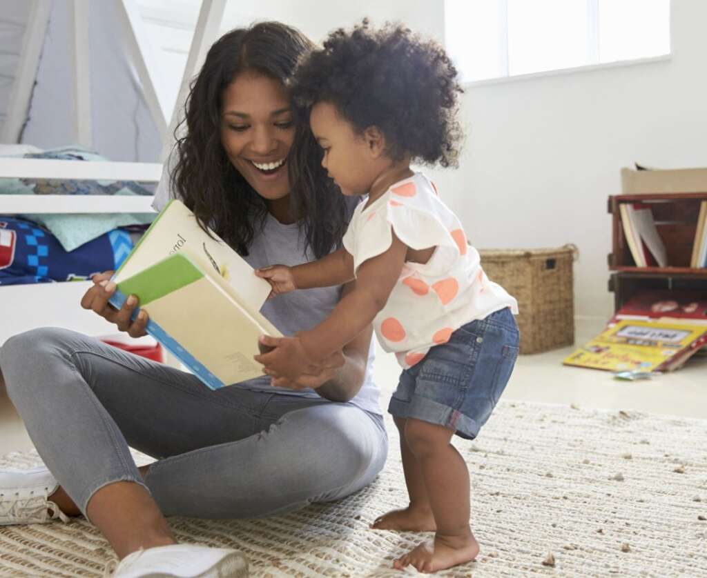 mother and baby are reading the book