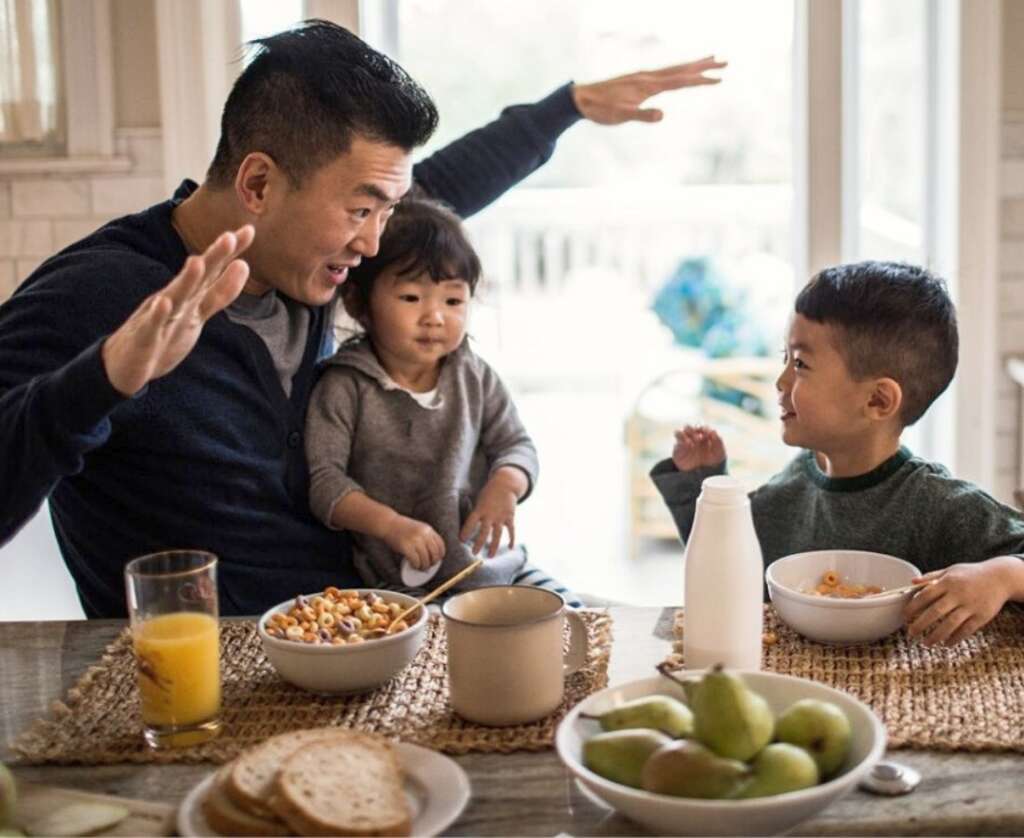 father and children are playing and doing breakfast